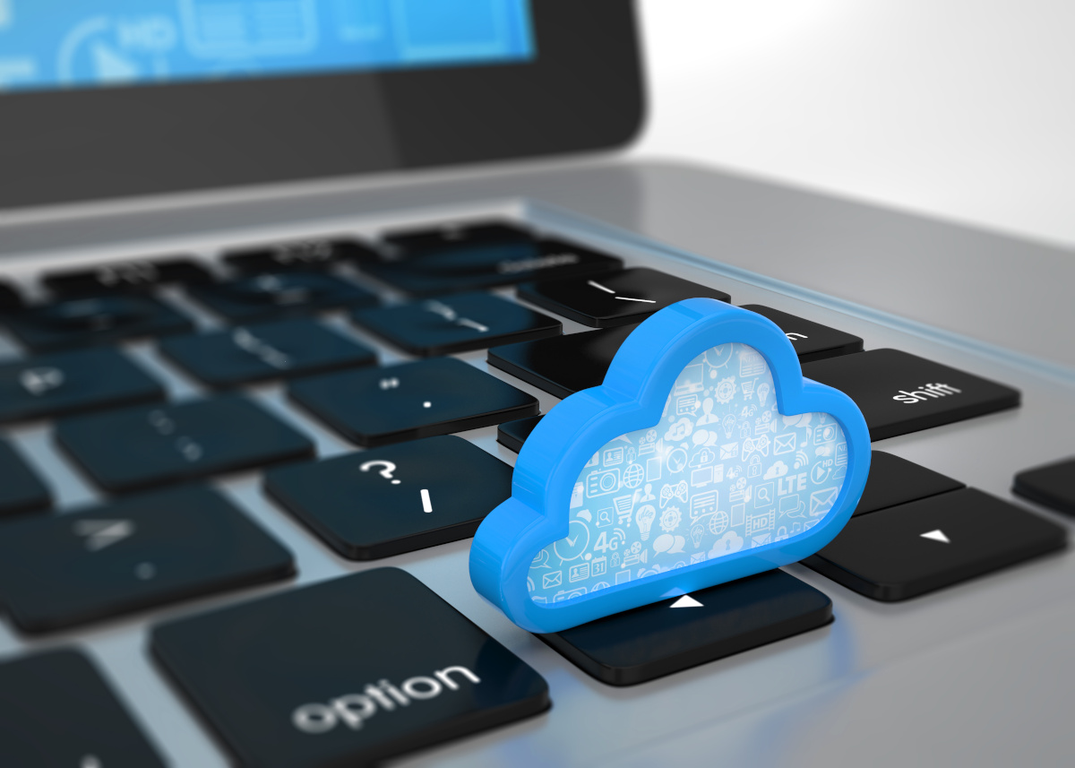 A digital blue cloud on a laptop keyboard