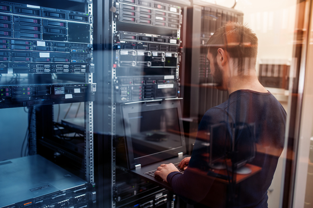 Young IT engineer in network server room